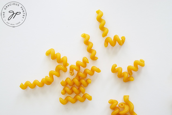 Dry cavatappi pasta on a white background.