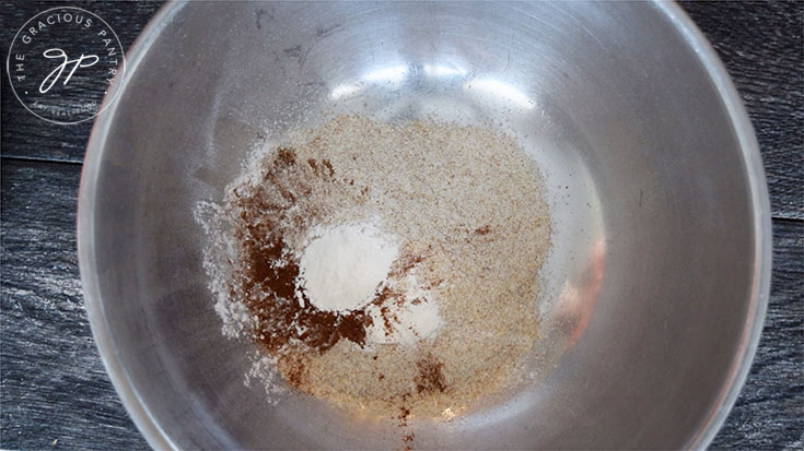 Adding all dry ingredients to the mixing bowl for this banana pancakes recipe.