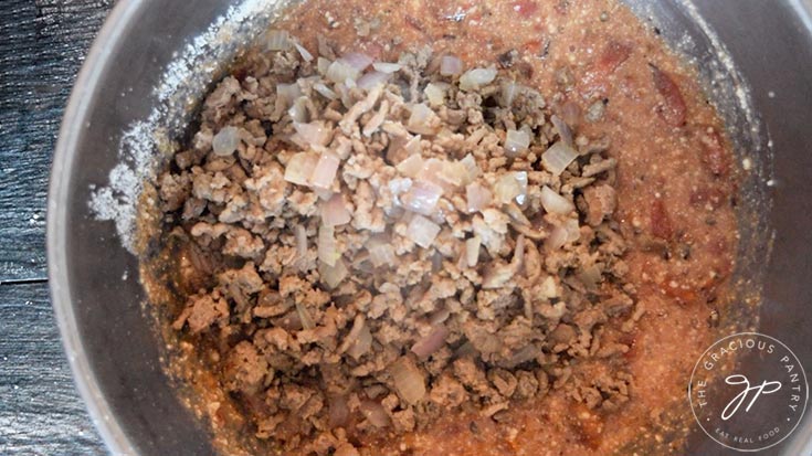 The cooked meat and onions added to the mixing bowl.