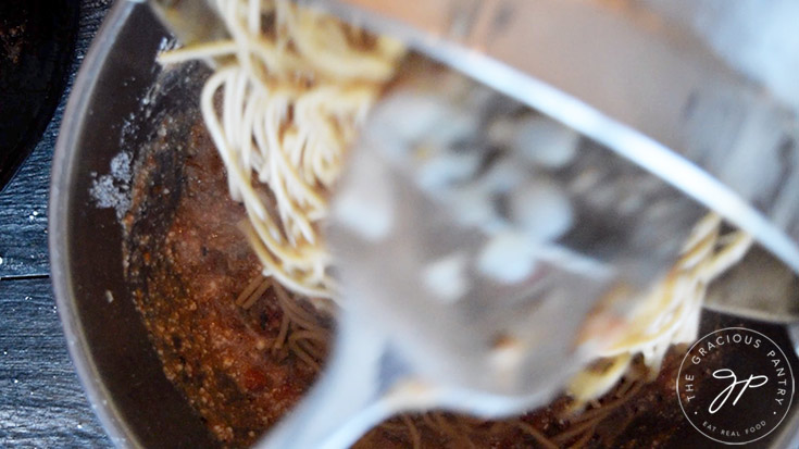 The pasta added to the mixing bowl to make spaghetti pie with.