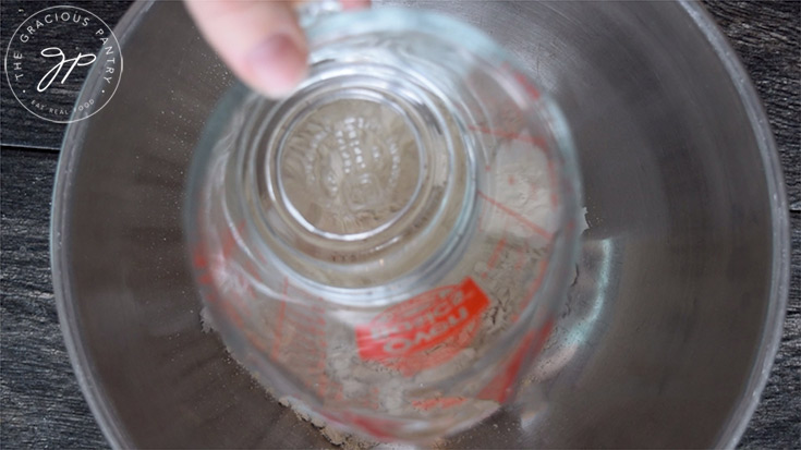 Adding the water to the mixing bowl.