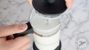 Frothing the milk in a french press.