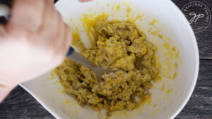 Mashing all the ingredients together in the mixing bowl