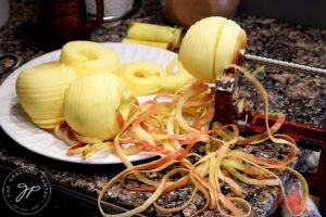 Apples being peeled on the apple peeler.