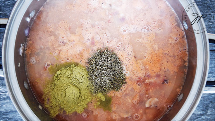 Adding spices to the lasagna soup recipe.