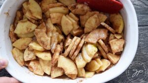 Apples coated with filling ingredients for this apple crisp.