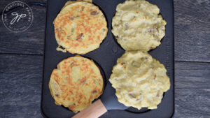 Flipping the potato pancakes on the pan for this Potato Pancake Recipe.