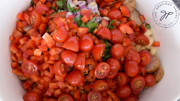 Fresh, halved cherry tomatoes added to the pasta.