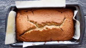 The finished cinnamon bread loaf, still in the loaf pan for cooling.