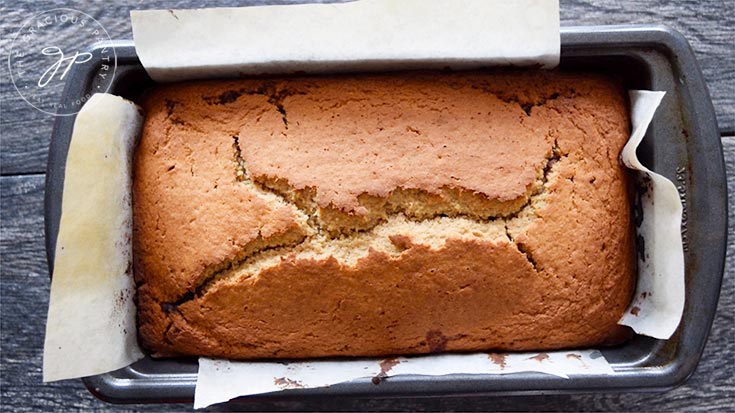 The finished cinnamon bread loaf, still in the loaf pan for cooling.