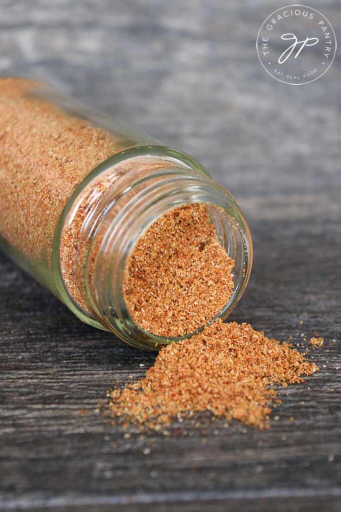 Taco Seasoning jar full of spices, tipped over and spilling out.