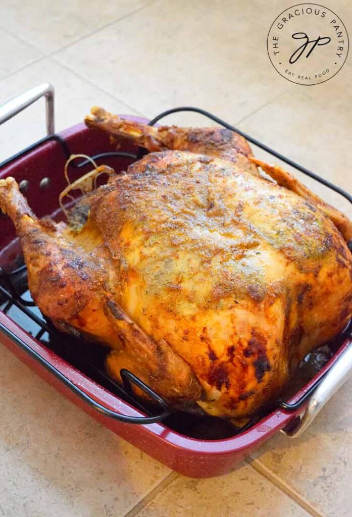 A roasted Thanksgiving turkey cooling in a roasting pan.