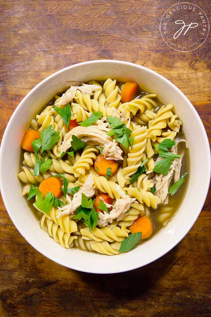 An overhead view looking down into a white bowl filled with this turkey soup recipe.