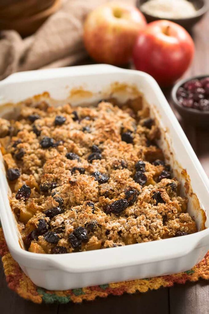 A white casserole dish sits on a table filled with a baked oatmeal recipe.