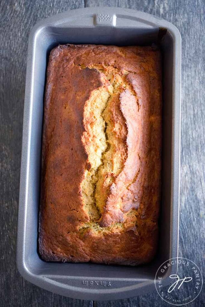 An overhead view looking down into a loaf pan of this Oat Flour Banana Bread as it cools.