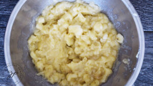 Step one of this Oat Flour Banana Bread recipe. The bananas mashed in a mixing bowl.