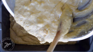 Pouring the Oat Flour Banana Bread batter into a loaf pan.