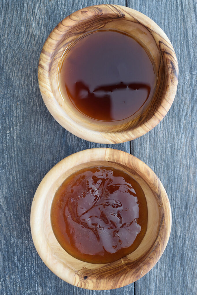 Two wooden bowls, one filled with honey, the other withe maple syrup for making cranberry relish.