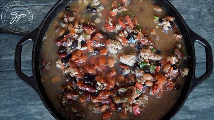 Adding broth to the Dutch Oven Chili Recipe