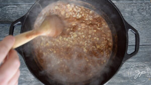 Stirring the spices into the oatmeal.