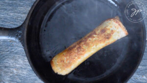 Cooking the Grilled Cheese Roll Up in a skillet. They can also be air fried.