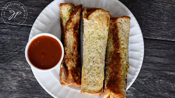 Serving the Grilled Cheese Roll Ups with a side of marinara for dipping.