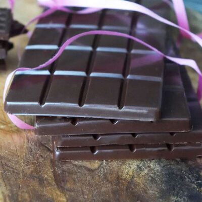 And up close shot of a stack of homemade chocolate bars with pink ribbon around them, made from this chocolate bars recipe.