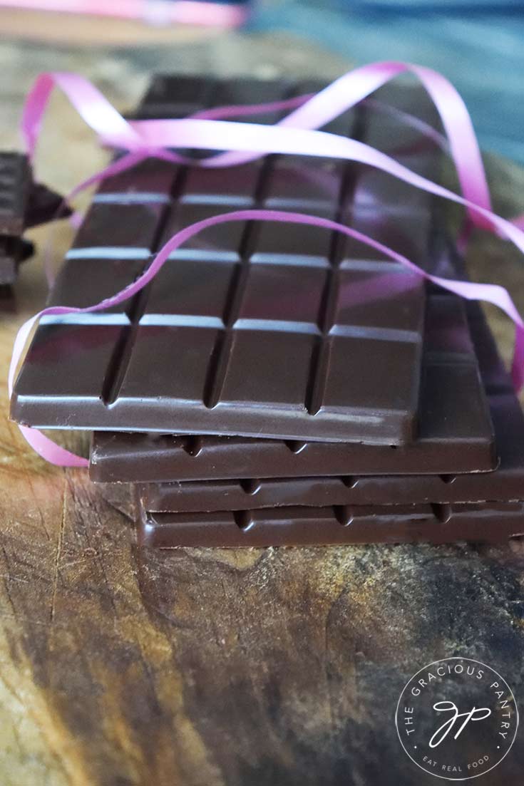 And up close shot of a stack of homemade chocolate bars with pink ribbon around them, made from this chocolate bars recipe.