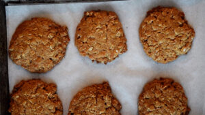 Hot, out of the oven, Peanut Butter Oatmeal Cookies on a cookie sheet.