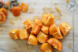 The persimmons cut and de-stemmed and ready to go into the slow cooker.