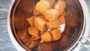 The persimmons, transferred to a colander to be mashed.