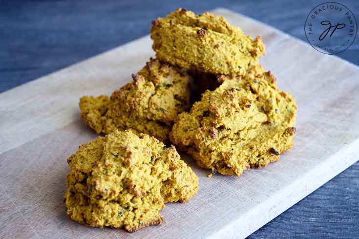 The finished low carb drop biscuits, piled up on a cutting board.