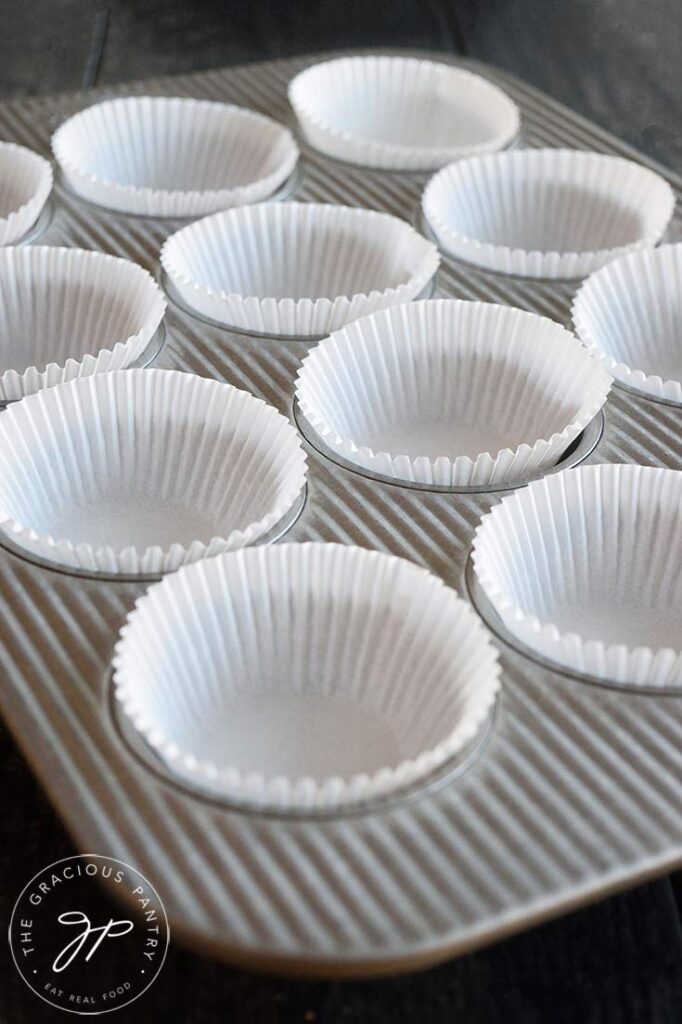 A muffin pan lined with cupcake papers.