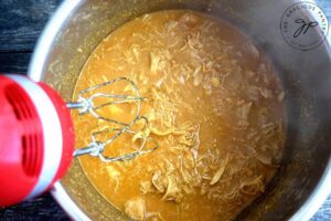 Blending the Honey Mustard Chicken in the Instant Pot after cooking, in order to shred the chicken.
