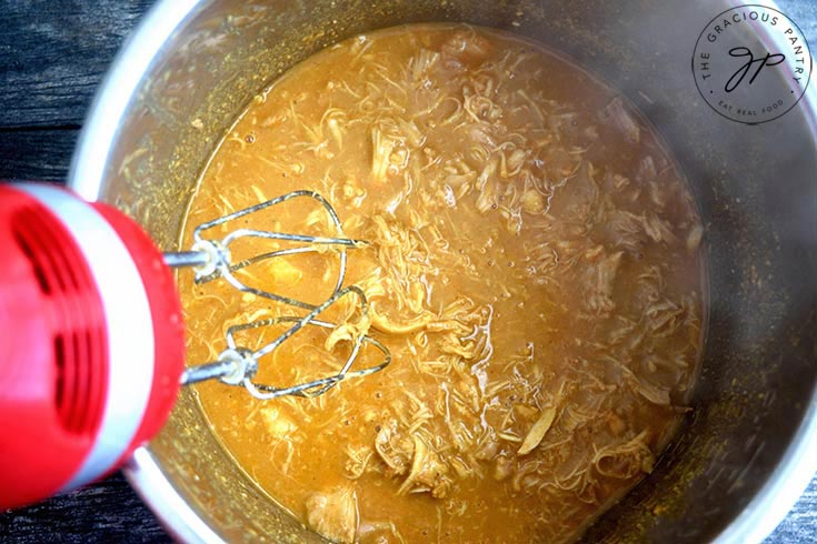 Blending the Chicken in the Instant Pot after cooking, in order to shred the chicken.