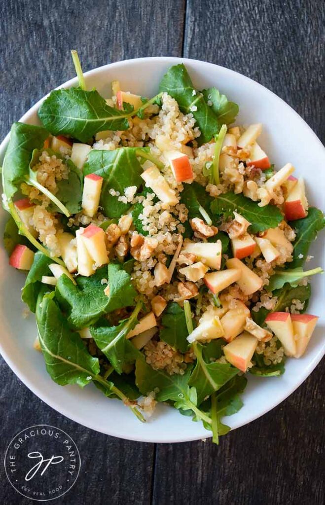 An overhead view of this Kale Quinoa Salad in a white bowl.