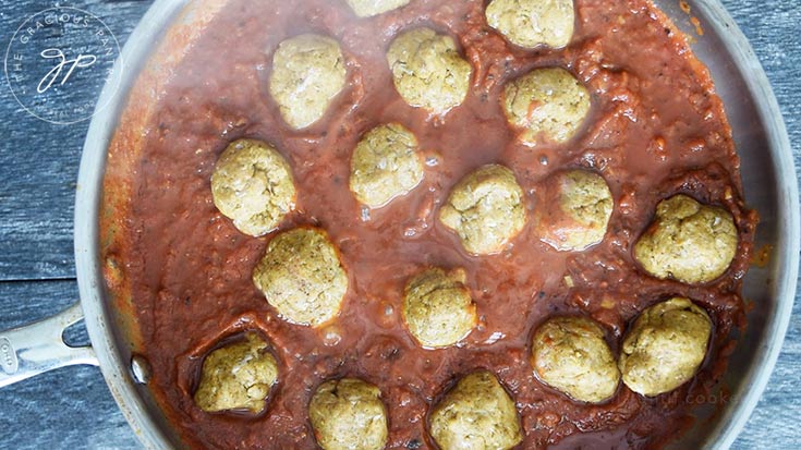 The meatballs simmering in the curry sauce.