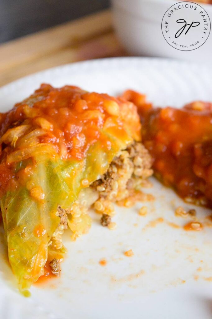 The finished Mexican cabbage rolls. One on a plate, cut open.