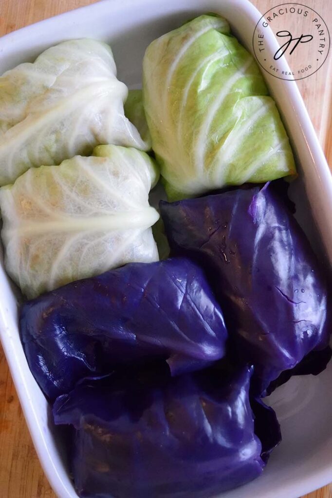 Rolled up Mexican cabbage rolls made with half green cabbage and half purple cabbage.