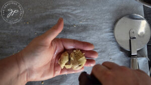 Keeping the remaining dough moist by spritzing it with a bit of oil.