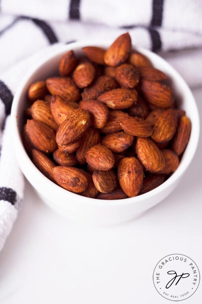 An overhead view of the almonds din a small white serving dish.