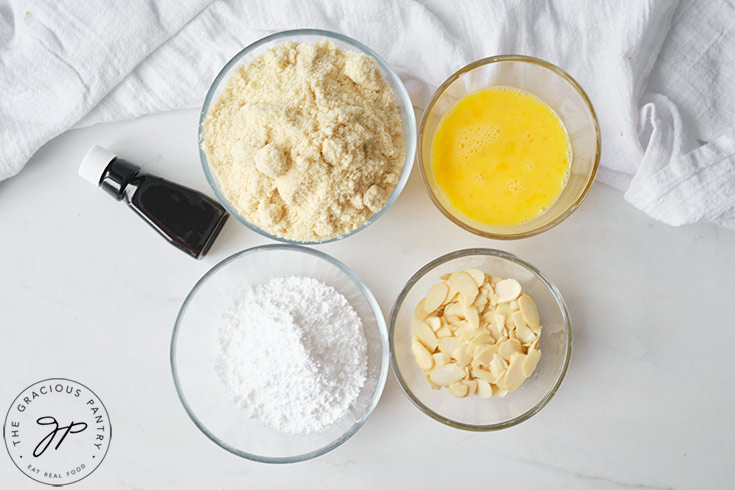 All the individual ingredients for this Almond Cookies Recipe in individual, glass bowls.