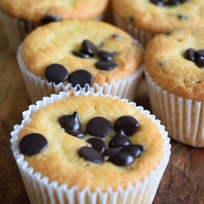 A double row of almond flour muffins sitting on a wooden surface.