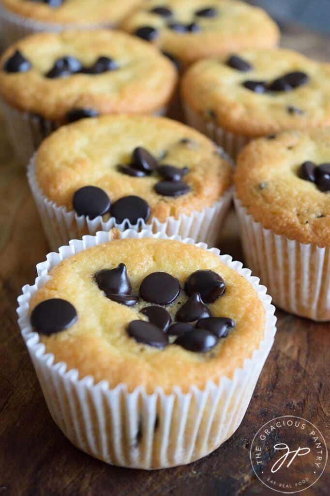 A double row of almond flour muffins sitting on a wooden surface.