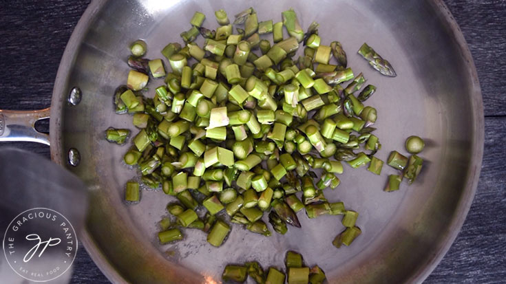Sliced asparagus in the skillet for sautéing this Asparagus Salad Recipe