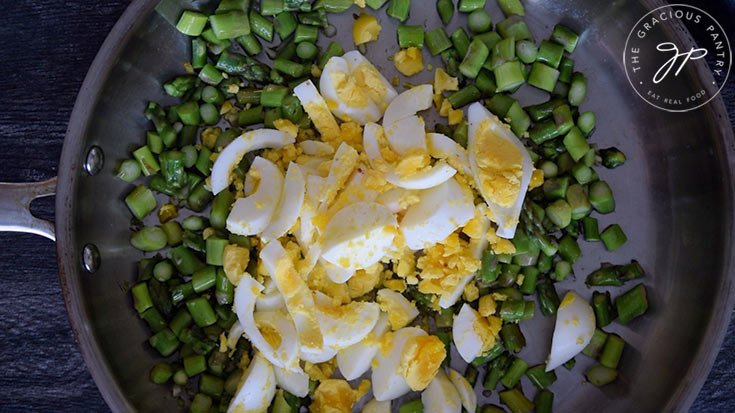 Stirring the egg into the skillet for this Asparagus Salad Recipe