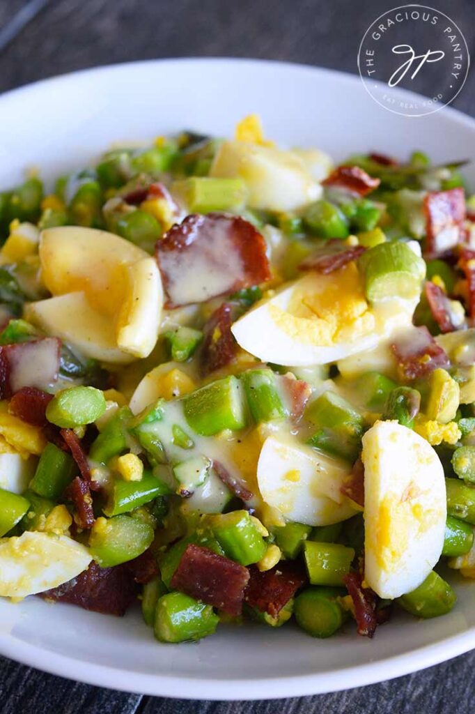 An up close view of this Asparagus Salad in a white serving bowl.