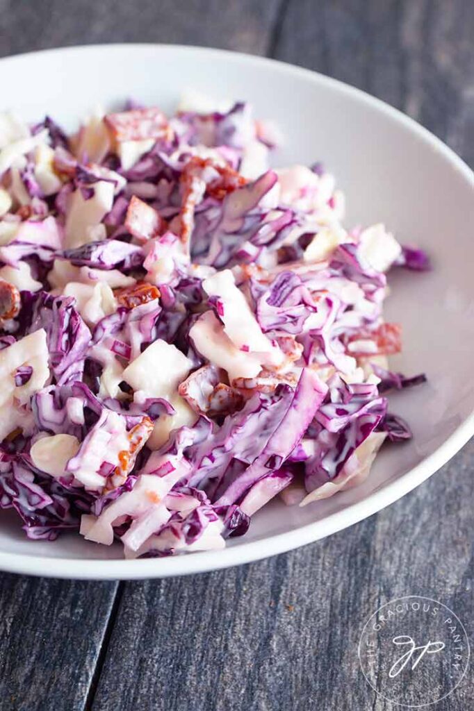 A sideview of this Cabbage Salad recipe in a white serving bowl.