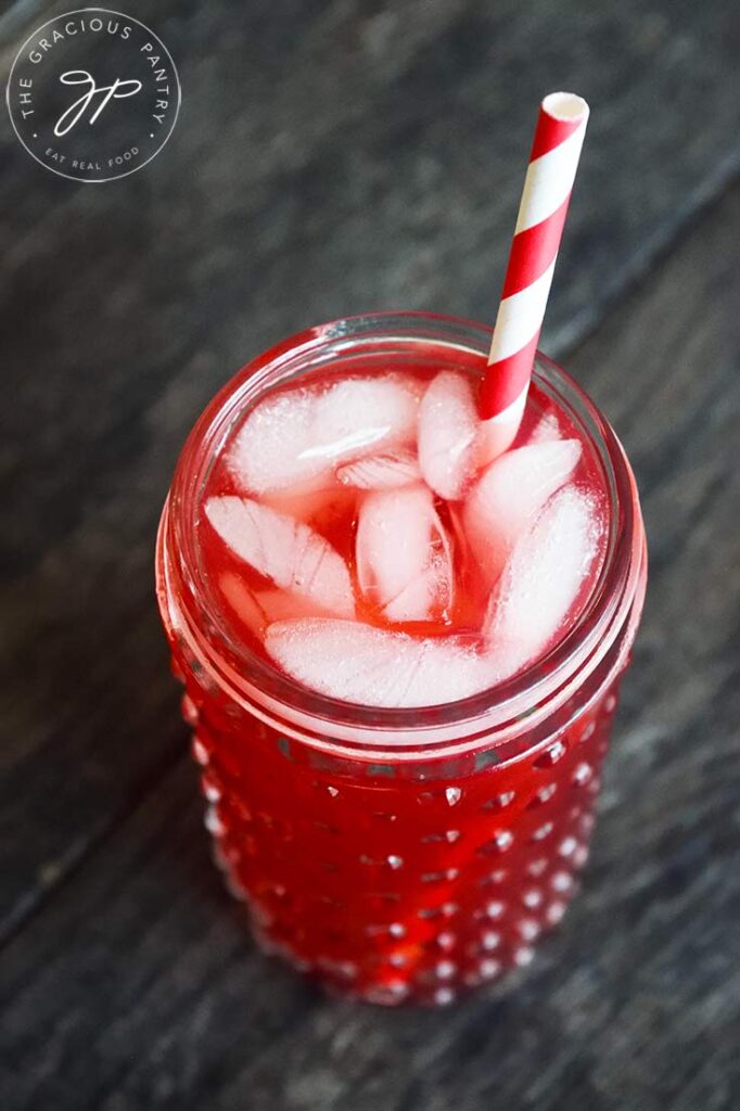 And overhead view of the Hibiscus Lemonade in a cup with ice and a straw.