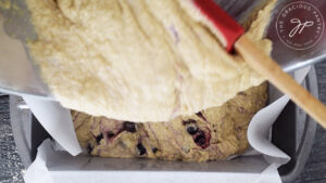 Pouring the batter into the loaf pan for this Lemon Blueberry Bread Recipe